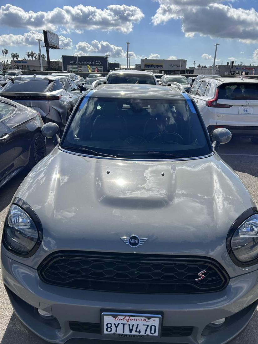 MINI Cooper Countryman with a freshly installed windshield, alignment tape holding the seal