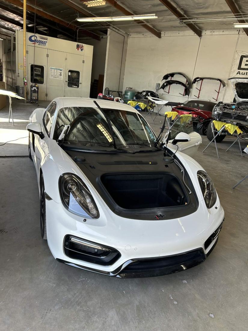 Porsche Cayman in the shop with its windshield removed for replacement