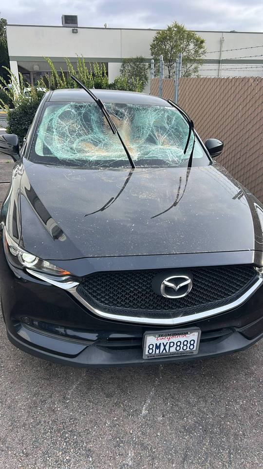 Windshield before replacement — shattered by road debris